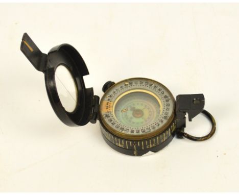A WWII compass by TG Co Ltd of London, inscribed "No B225603 1943 Mk III", and bearing military arrow symbol.