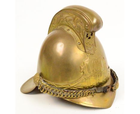 A late 19th century brass fireman's helmet with early LCC LFB wrap around badge, complete with leather liner and brass chin s