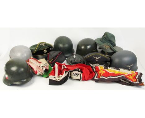 A collection of German replica militaria for film props, including helmets, banners etc. CONDITION REPORT: Postage within UK 