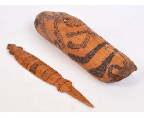 An Australian food carrier with incised burnt decoration, length 47cm, and a goanna shaped carving with similar decoration, l
