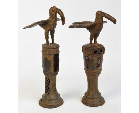 Two similar 16th century Benin bronze staffs of office surmounted with a stylised bird above pierced central column and sprea