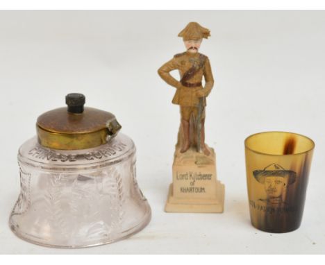 A commemorative pressed glass inkwell for the death of Gordon of Khartoum, a bisque porcelain figure depicting Lord Kitchener