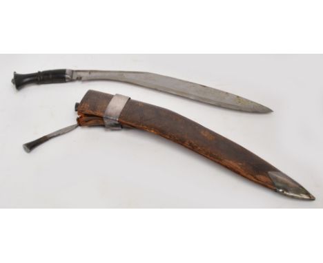 An early 20th century Eastern kukri knife with horn handle, with scabbard housing two smaller daggers, length 53cm. CONDITION