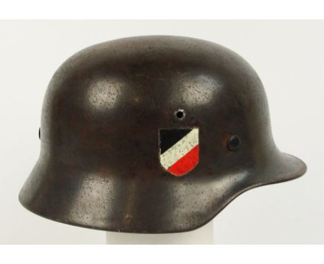 A German M40 steel helmet with two later applied decals and later liner.