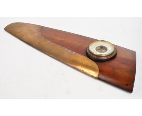 A WWI aircraft wood and brass propeller tip housing a later circular barometer, height 72cm.