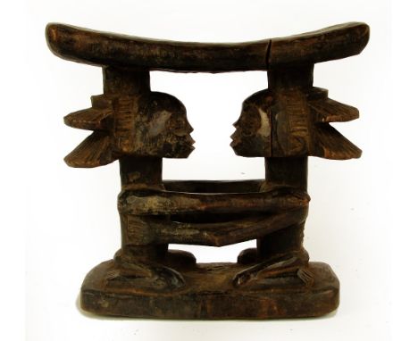A Luba headrest, Democratic Republic of the Congo, modelled as two kneeling figures representing the Luba matrilineal ancesto