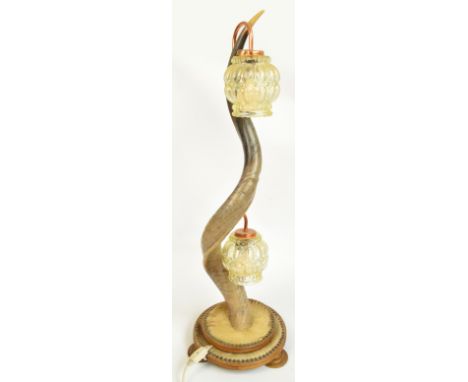 A Kudu horn lamp set with two moulded shades above a stepped circular base, height 93cm.