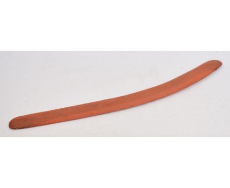 An early 20th century Australian Aboriginal incised shallow curved boomerang with fluted decoration to one side and red pigme
