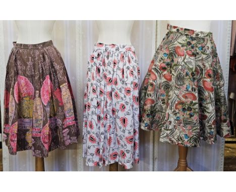 Three 1950's full circle skirts, two cotton with bright print, a stiffened felt full circle skirt printed with flowers and go