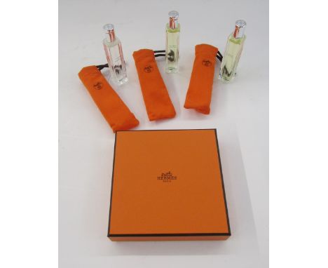 Set of three Hermes eau de toilette natural spray bottles, each in orange bag, 15ml, 'Le Jardin de Monsieur Li' and two 'Un J