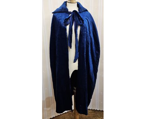 A 1920's blue velvet evening cloak with ruched collar and a 1920's bottle green velvet bolero jacket with paste button detail