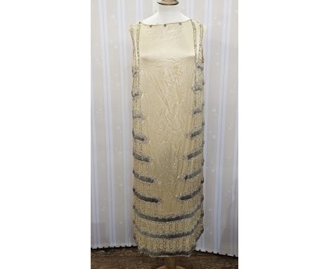 1920's cream satin dress,&nbsp; embroidered with silver thread and bugle beads, the collar has been removed, and a pink chiff