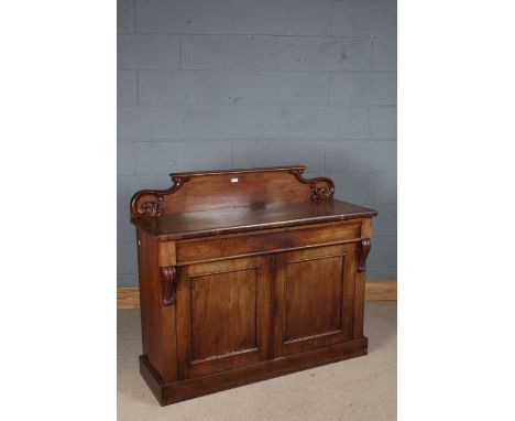 Victorian mahogany chiffonier, the scroll carved upstand above two panelled cupboard doors opening to reveal a single shelf a