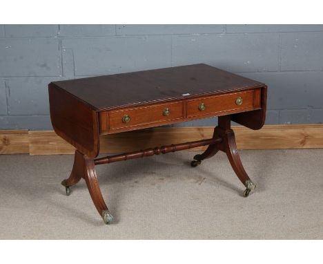 Regency style mahogany low sofa table, the rectangular banded top with D ends, above two frieze drawers either side, of which