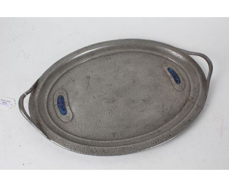 Arts and Crafts enamel mounted beaten pewter serving tray, of oval form with pierced carrying handles, 50cm wide, 35cm deep