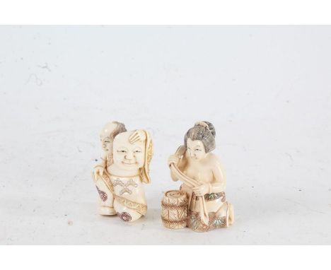 Two Japanese Meiji period carved ivory netsuke, the first in the form of a kneeling man holding a mask, character mark to bas