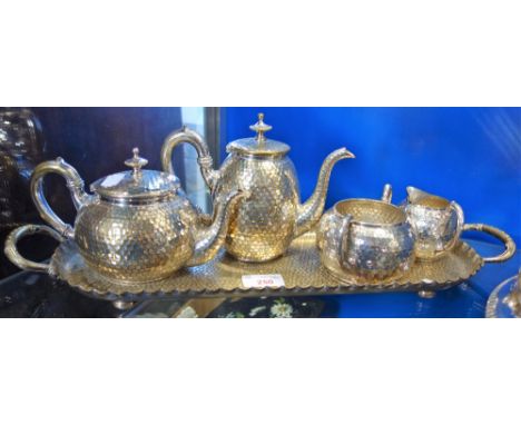 A WMF FOUR PIECE SILVER PLATED TEA SET, of Arts & Crafts style with planished decoration on a matching tray