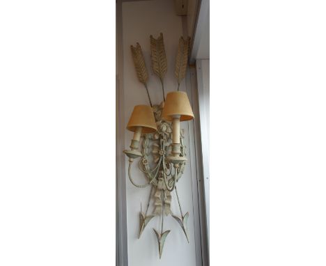A CARVED WOODEN WALL LIGHT with gesso decoration, in the form of a tied ribbon with three arrows, 100 cm high 