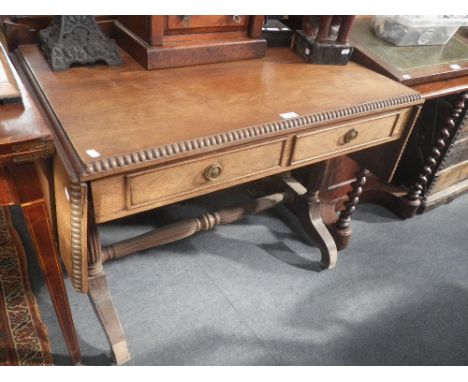 A REGENCY ROSEWOOD SOFA TABLE, the flap support brackets with carved decoration, 92cm wide