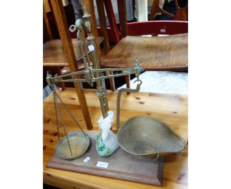 A SET OF BRASS APOTHECARY SCALES on a mahogany base 