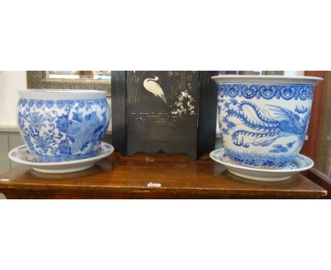 A LARGE CHINESE BLUE AND WHITE GARDEN PLANTER, 32 cm high, a similar fish bowl and a pair of saucers decorated with dragons, 