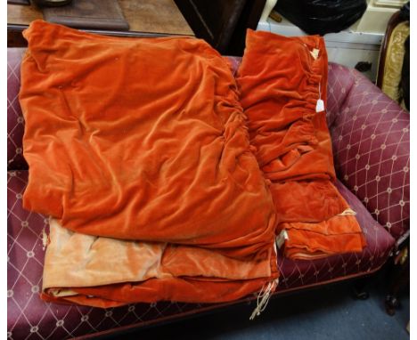 A LARGE PAIR OF ORANGE VELVET CURTAINS