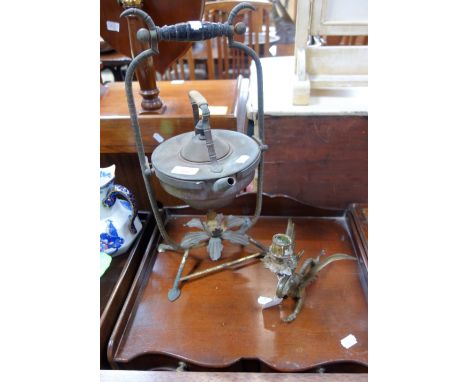 A VICTORIAN BRASS KETTLE ON STAND and a brass candlestick in the form of a mythical beast (2)