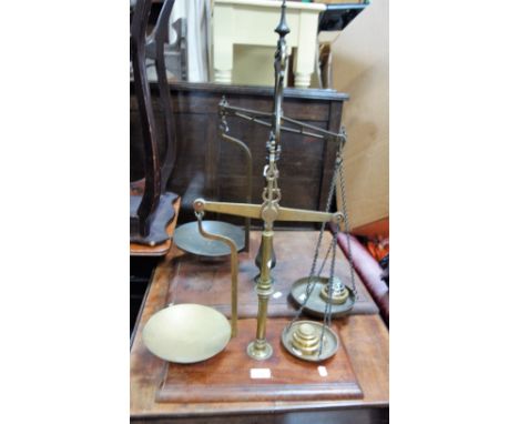 A LARGE SET OF 19TH CENTURY BRASS SCALES with a mahogany base and a smaller set
