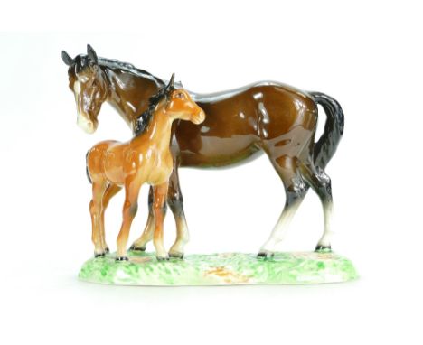 A Beswick model of brown Mare and chestnut Foal, No 953, on ceramic grassy base