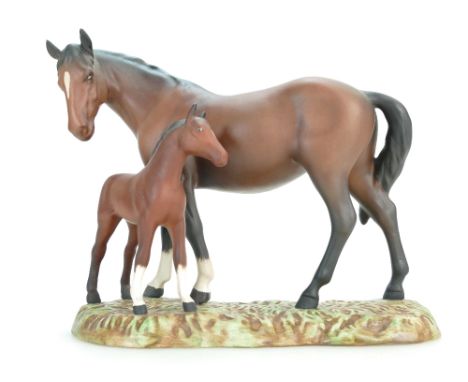 A Beswick model of matte brown Mare and Foal, No 953, on ceramic grassy base