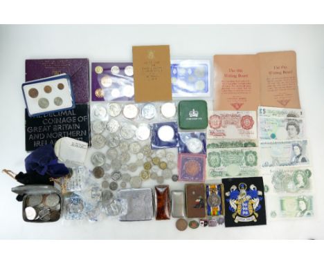 A good collection of coins including silver coins, proof coin sets, banknotes, commemorative coins, enamelled badges, first w