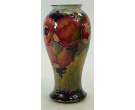William Moorcroft Burslem vase decorated with Pomegranates on light green/yellow ground, height 22.5cm.