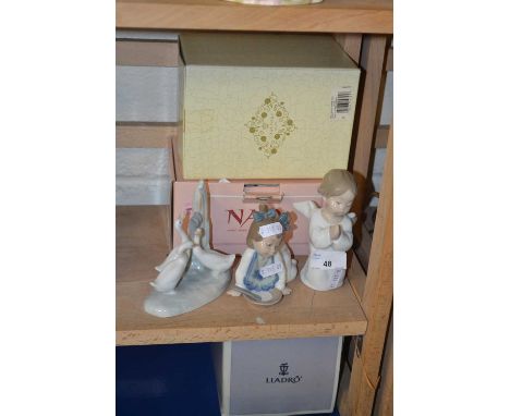 A collection of three small Lladro and Nao ornaments