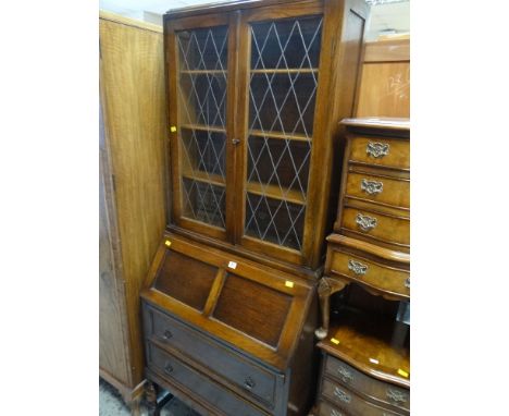 VINTAGE OAK BUREAU BOOKCASE on raised baluster legs with lead glazed upper doors