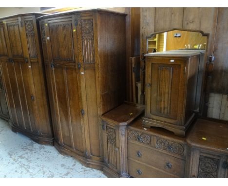 GOOD VINTAGE CROWN BEDROOM SUITE with carved Gothic and linen-fold decoration, comprising two drawer wardrobe, single door wa