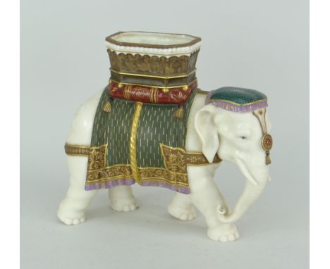 ROYAL WORCESTER PORCELAIN IVORY GLAZED DOMESTIC INDIAN ELEPHANT MODEL with painted and gilded howdah, 19cms high