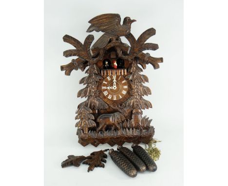 BLACK FOREST CARVED CUCKOO CLOCK featuring stag and rotating figures, complete with original instructions from 'Dold Exquisit