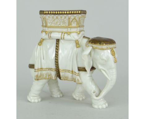 ROYAL WORCESTER PORCELAIN IVORY GLAZED DOMESTIC ELEPHANT MODEL, the howdah and dress picked out in gold, 15.25cms high