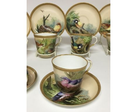 A 19 th century Worcester ornithological painted part tea set with gilt And jewelled rims painted with various bird studies c
