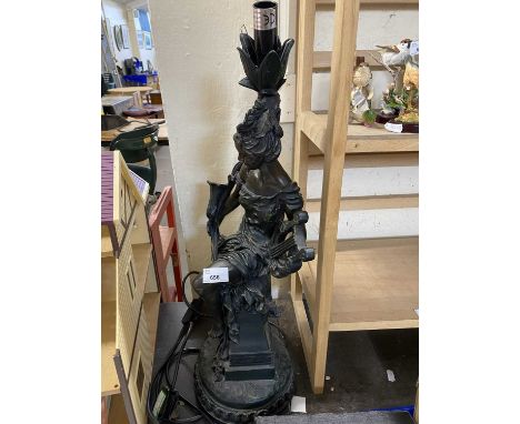 Resin modelled lamp of a seated lady holding a lyre with orange and green trumpet glass shade, approx 69cm high 