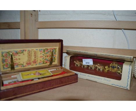 Case of playing cards together with Her Majestys Golden State Coach model