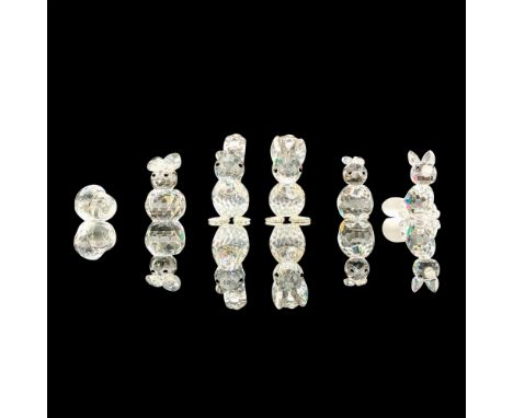 A set of 5 clear crystal Swarovski figures that depict various animals that can be found in a forest and one acorn. The figur
