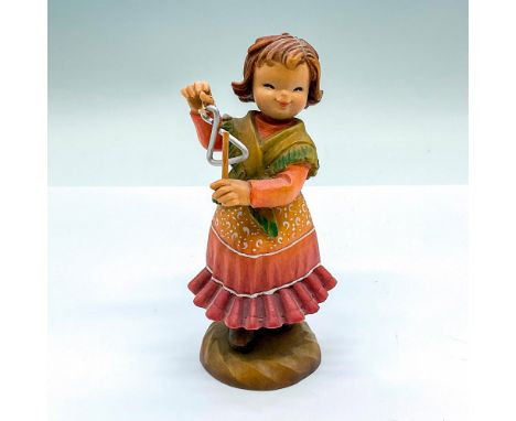 Limited edition. A vintage carved figure of a young girl playing the triangle. Artist carved name on the side. Limited editio