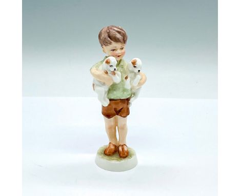 Small hand decorated figure of a young boy holding two puppies under his arms. Green and brown coloration. Royal Worcester ba