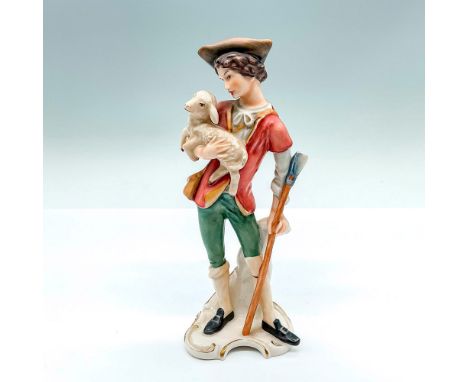 Hand painted figure of a young man holding a lamb. Goebel stamped. Model number: FR24. Issued: 1969Dimensions: 3.5"L x 2.5"W 