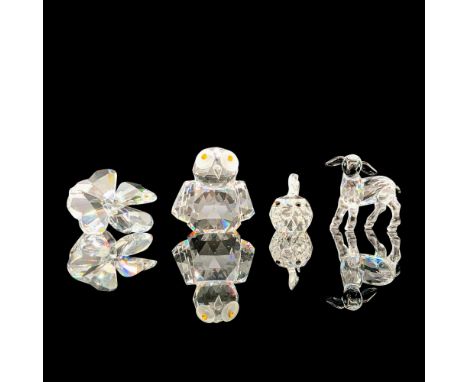 A set of four clear crystal figures depicting an owl, lamb, blowfish, and a four-leaf shamrock. The owl has yellow crystal us
