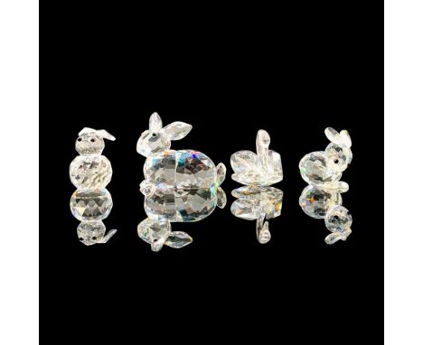 A set of four clear crystal figurines, 3 rabbit figures and 1 swan figure. The four figures are Resting Rabbit 014848, Mini R