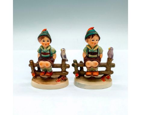 Hand painted and decorated figure of a young boy seated on a fence with a bird. Goebel Hummel backstamps. Issued: 20th centur