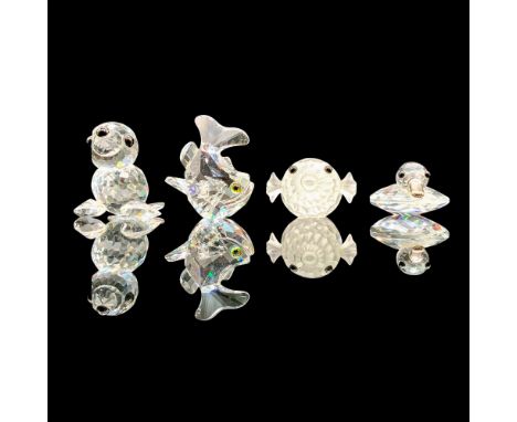 A set of four clear crystal figures that depict various ocean life. The four figures are, Mini Seal 012530, Mini Blowfish 013