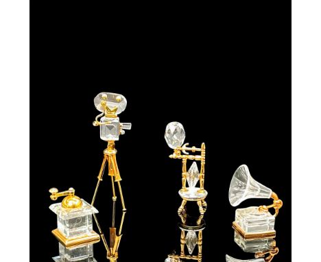 An assortment of clear crystal figures with gold plated metal accents. Includes 1 coffee grinder, 1 gramophone, 1 spindle whe